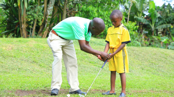 Afriyea Golf Academy's founder, Isaiah Mwesige and student